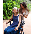 Woman in a wheelchair with another woman outdoors