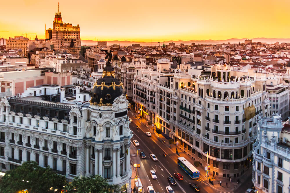 Madrid cityscape with illuminated buildings at sunset
