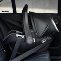 Black car seat with straps inside a vehicle