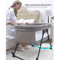 Woman using a baby bassinet with wheels in a bedroom setting