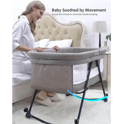 Woman using a baby bassinet with wheels in a bedroom setting
