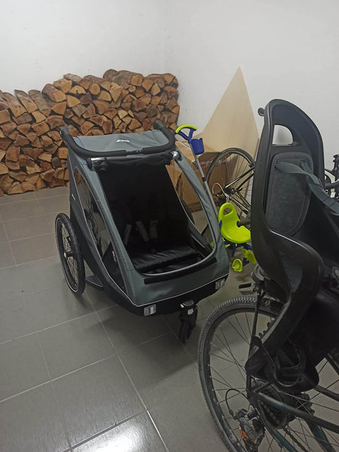 Bicycle with a child seat attached in a garage setting.